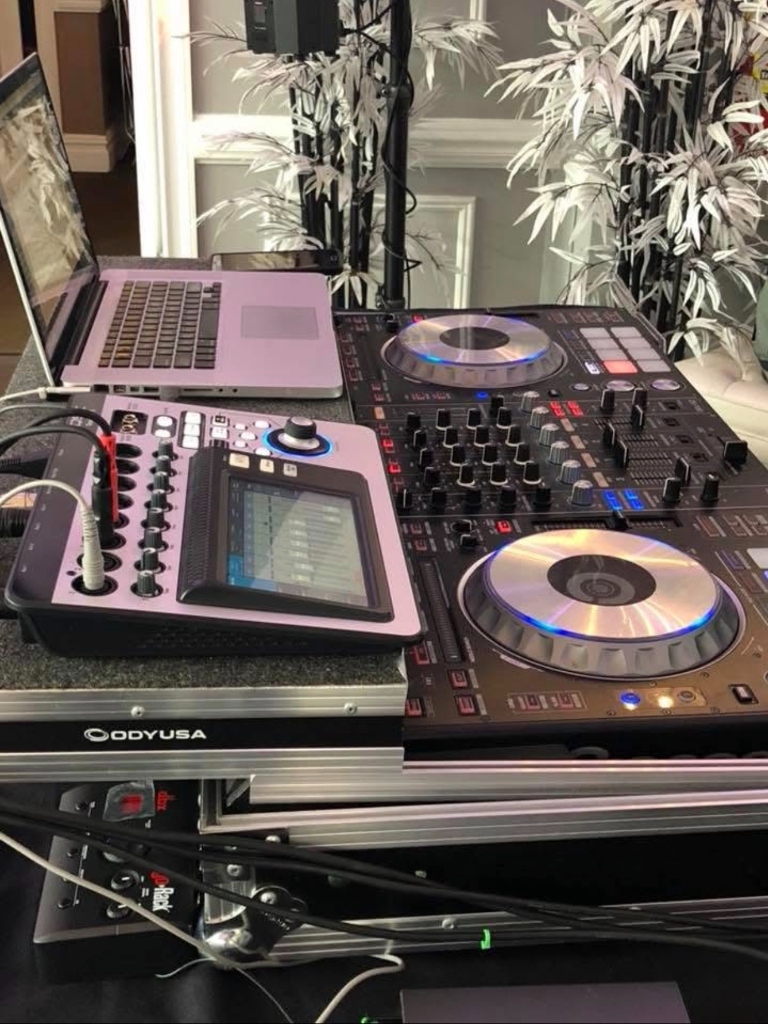 Close-up of the mixing console and processor mounted in a flight case beside a laptop.